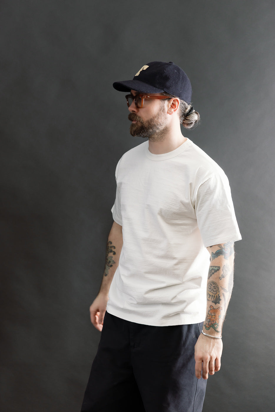 Male model 5'9 165lbs athletic build wearing Dubble Works off-white midweight tee, front side, full body