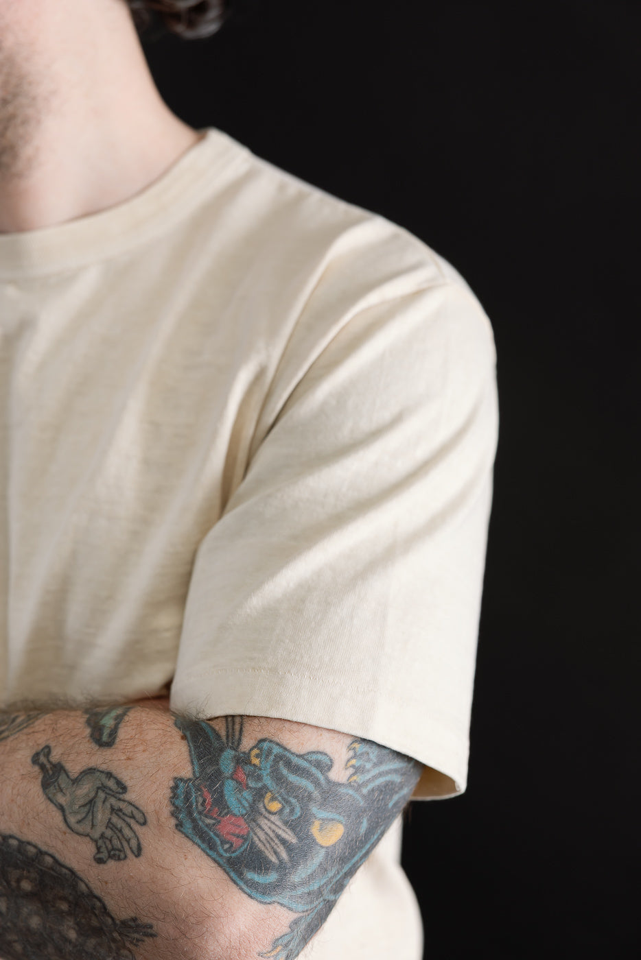 Close-up of Dubble Works Fallen Cotton midweight cream tee, male model 5'9