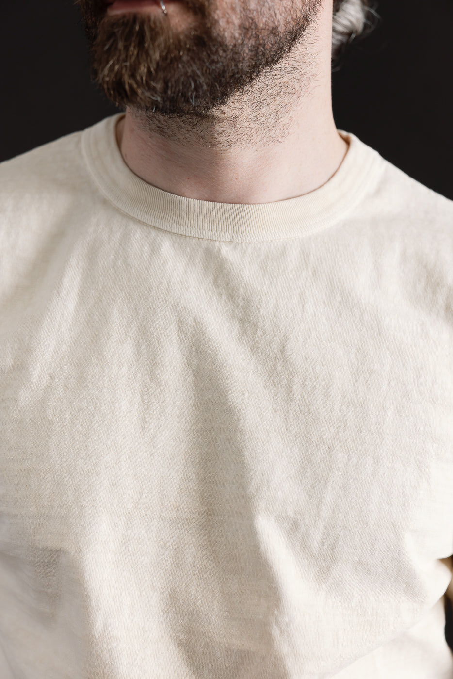 Close-up of cream Dubble Works midweight tee front, male model 5'9