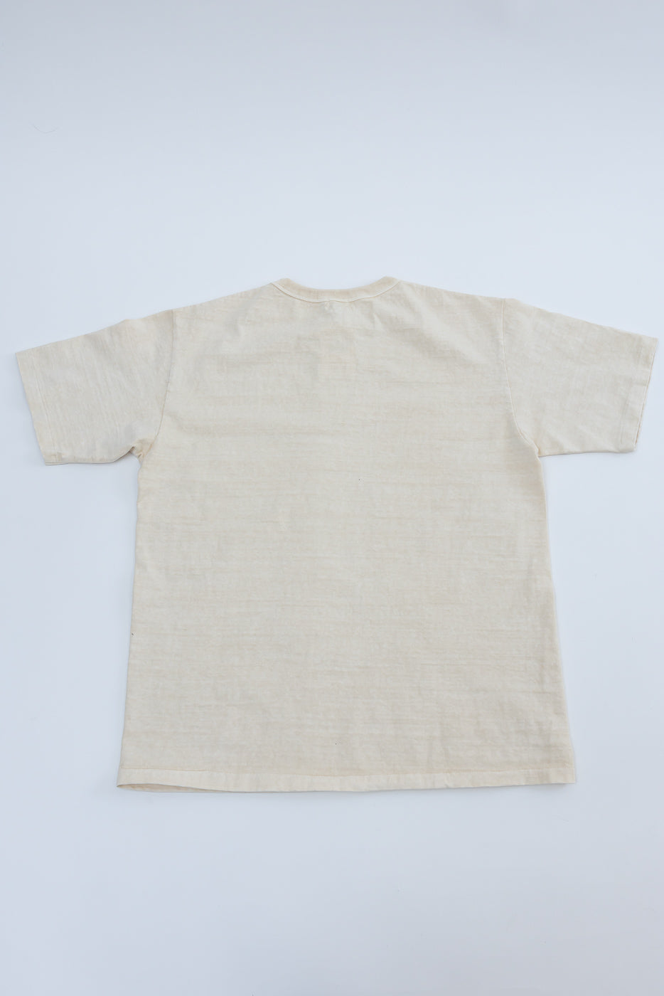 Flat lay of Dubble Works cream midweight cotton tee, back view, short sleeves, straight hem