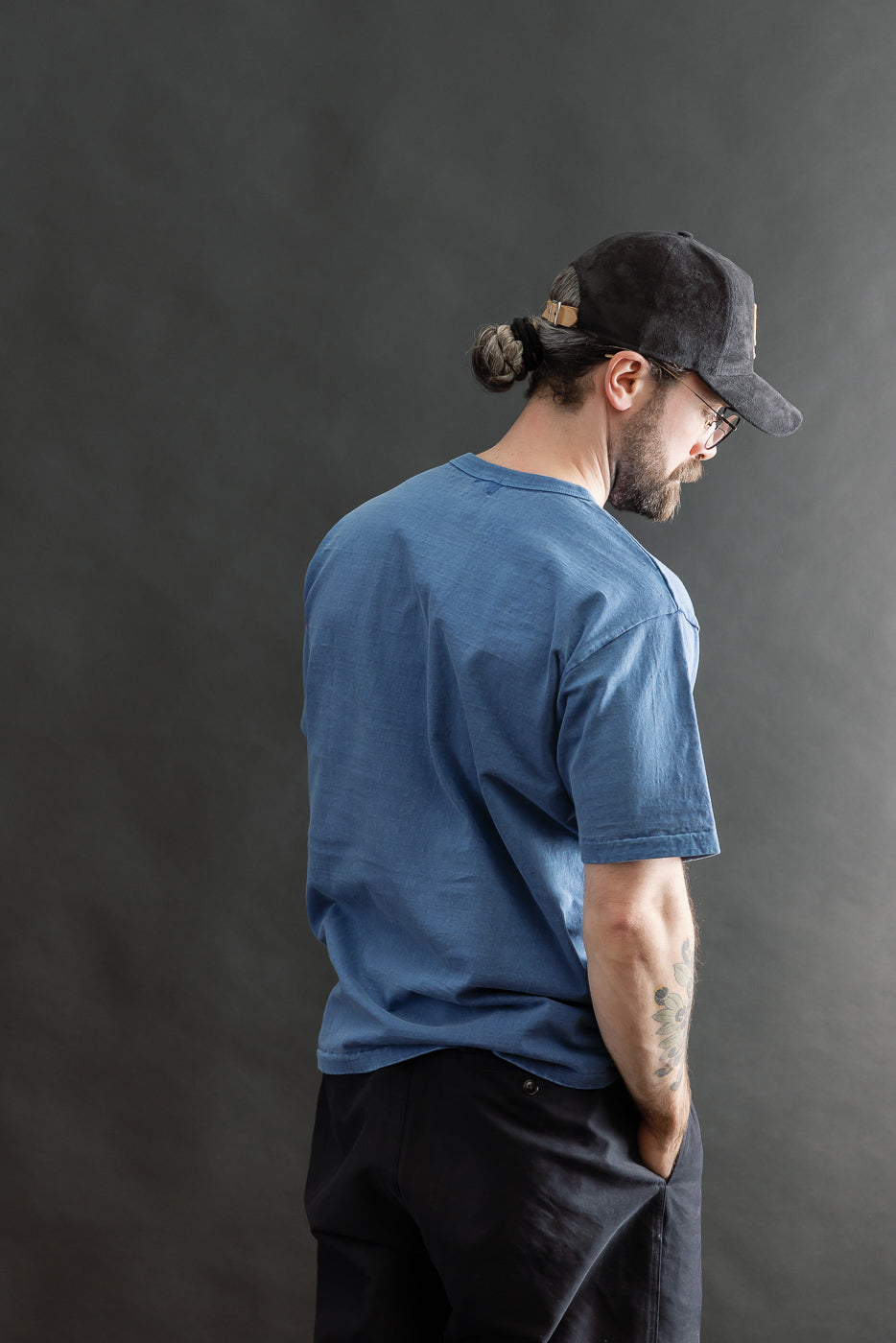 Male model 5'9” 165lbs athletic build wearing Dubble Works light indigo tee, back view