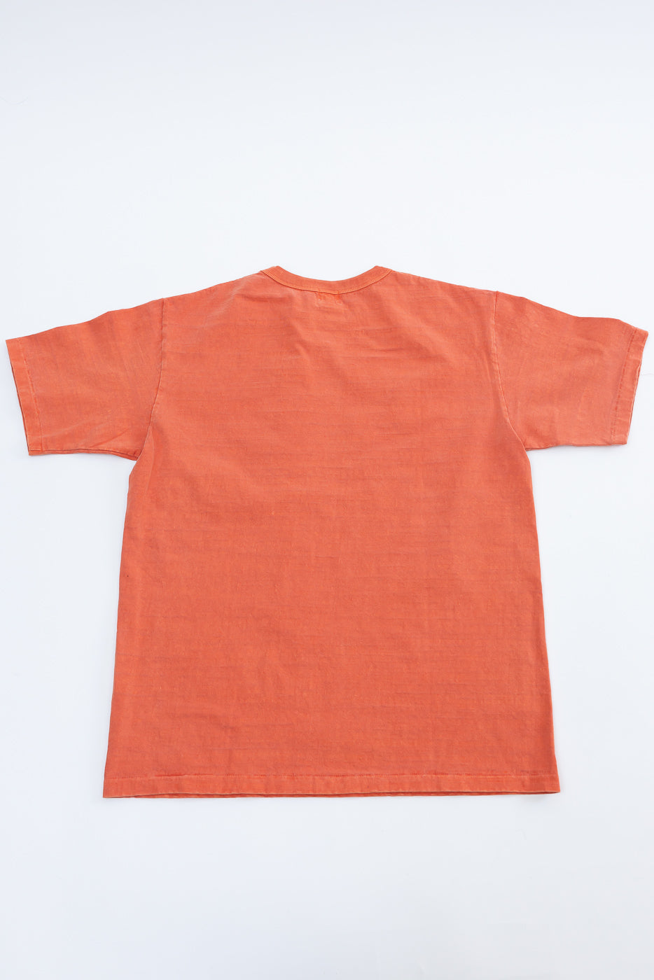 Flat lay of Dubble Works fallen cotton orange tee, back view, short sleeves, midweight fabric