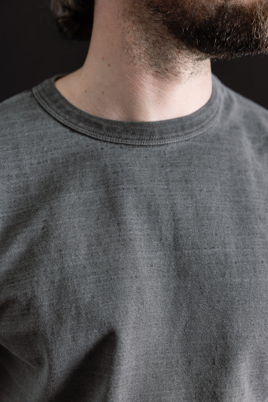 Close-up of male model wearing Dubble Works Fallen Cotton midweight tee, front collar detail