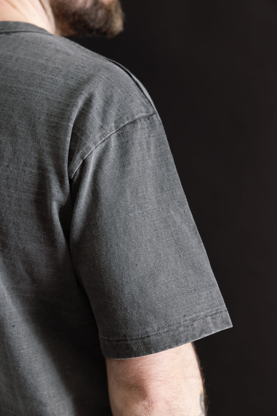 Close-up of Dubble Works Fallen Cotton midweight tee sleeve, right side, on 5'9