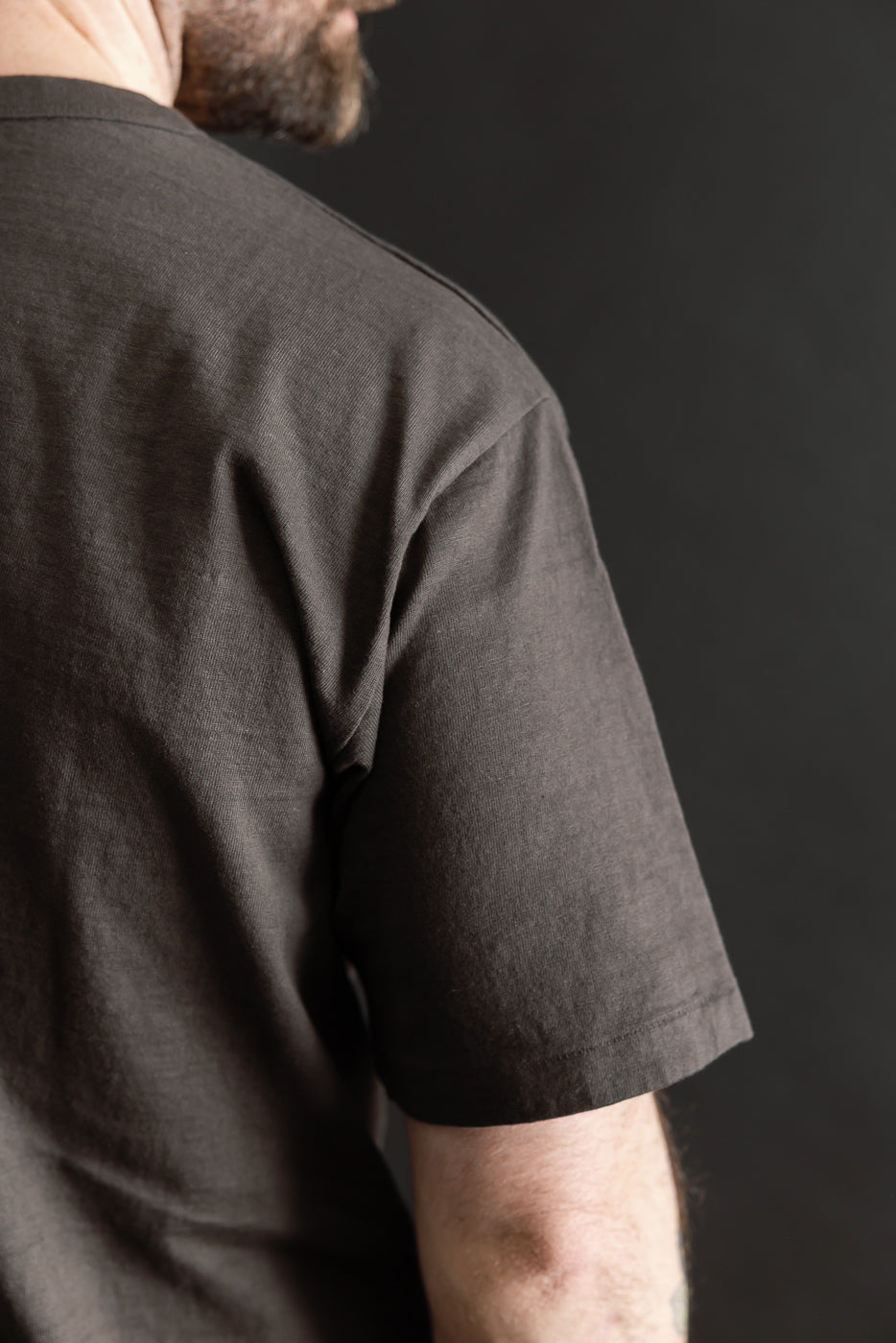 Close-up of back and sleeve of Dubble Works Sumikuro black tee on male model, 5'9