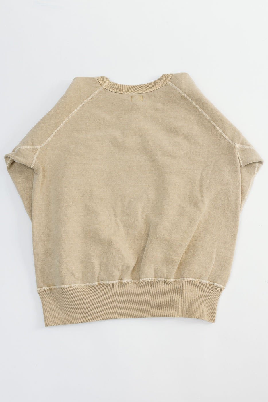 Flat lay of a beige sweatshirt, back view, showing raglan sleeves, ribbed hem and collar.