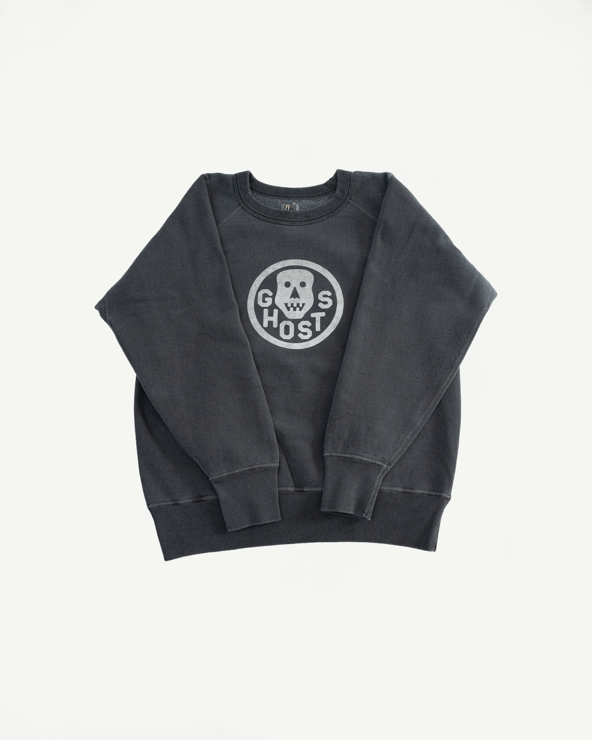 Flat lay of black faded crewneck sweatshirt, front side with 'Ghosts' graphic and ribbed cuffs.