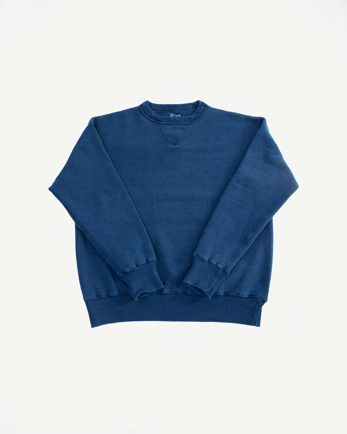 Flat lay front view of indigo dyed loopwheel crewneck sweatshirt, showing collar, cuffs, and hem details.