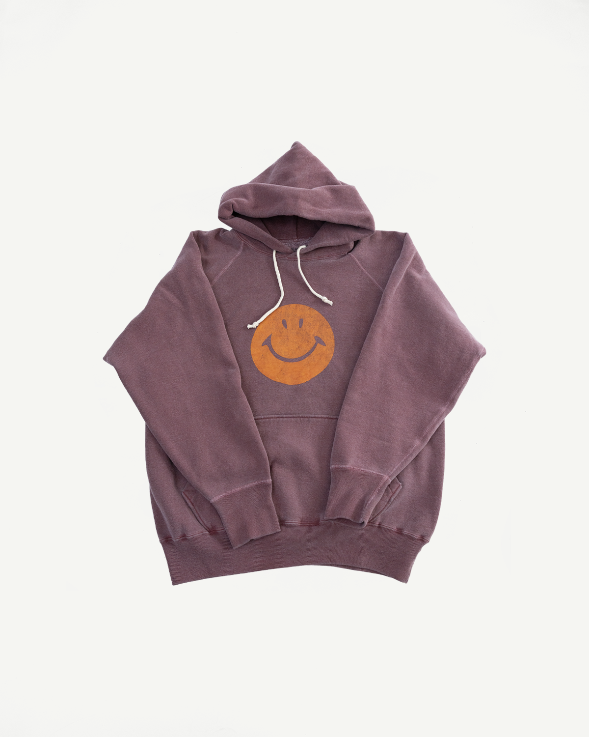 Flat lay of bordeaux faded print hoodie, front view, showing smiley graphic and drawstring hood.