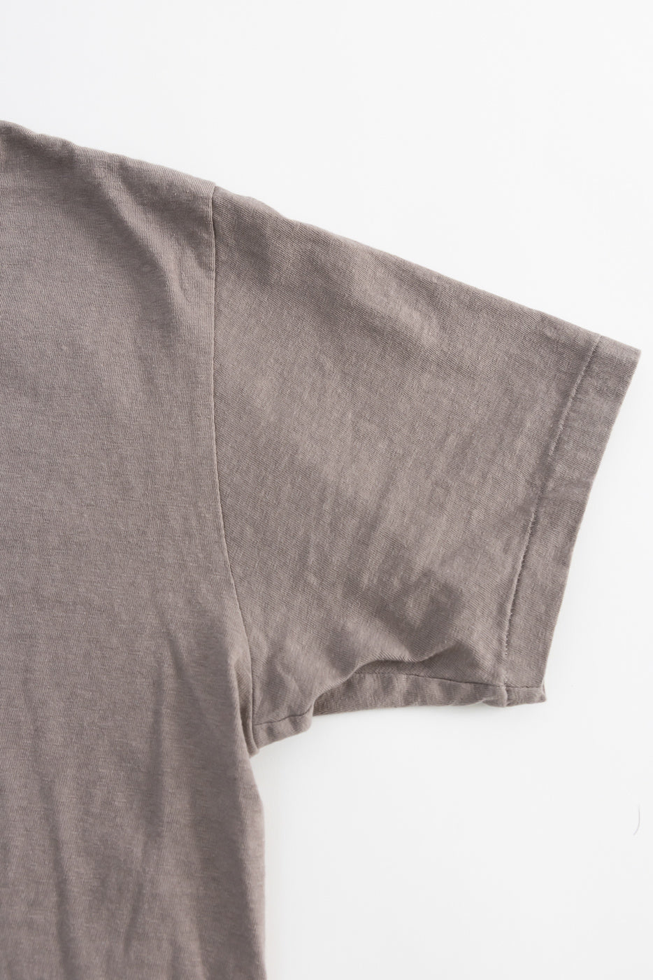 Close-up of the 5.4oz Raffy Tenjiku Printed T-Shirt Skull & Crossbone in Grey, highlighting the seamless tubular construction and nep-textured fabric, inspired by 1960s American vintage tees.