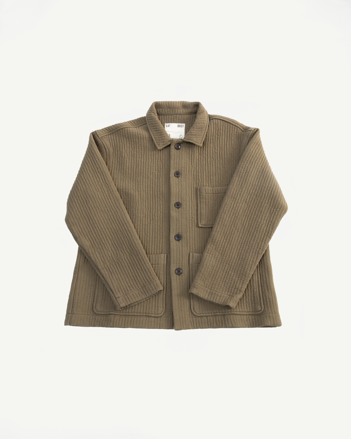 Front flat lay of Eat Dust Fjord Jacquard Fossil Green shirt jacket, textured cotton, visible buttons, three patch pockets, at Dant contemporary apparel.