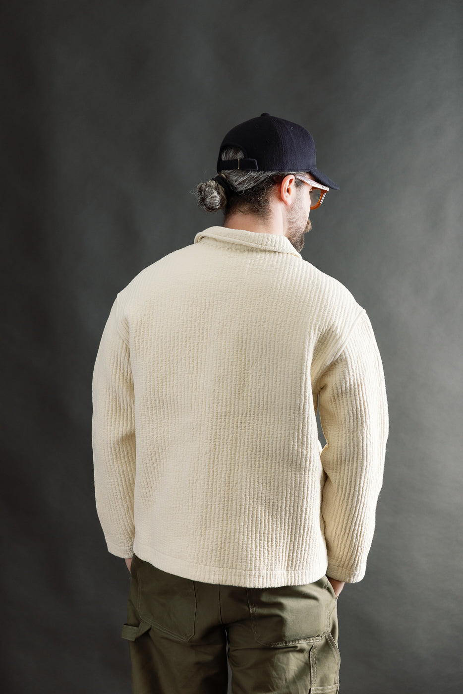 Male model 5'9 165lbs athletic build wearing wheat jacquard shirt, back view, textured fabric