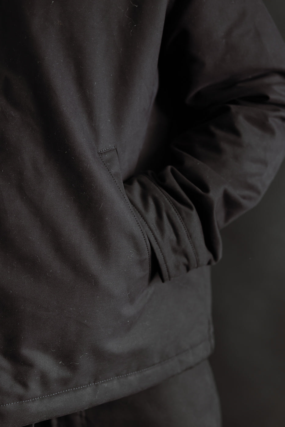 Close-up of Eat Dust Dago Jacket in black Nebraska cotton, male model 5'9 165lbs, front side pocket detail