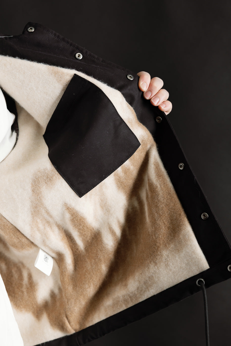 Close-up of Eat Dust Dago Jacket interior, showing soft lined Nebraska cotton, black pocket, and inner snap button details.