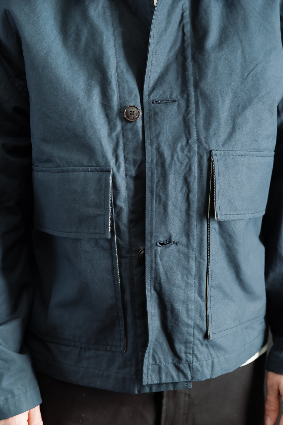 Close-up front view of Eat Dust Creek Jacket in dry wax cotton, male model 5'9