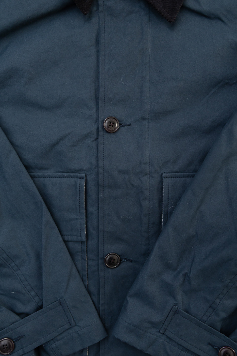 Close-up front view of Eat Dust Creek Jacket in dry wax cotton, showing buttons, flap pockets, and collar detail.