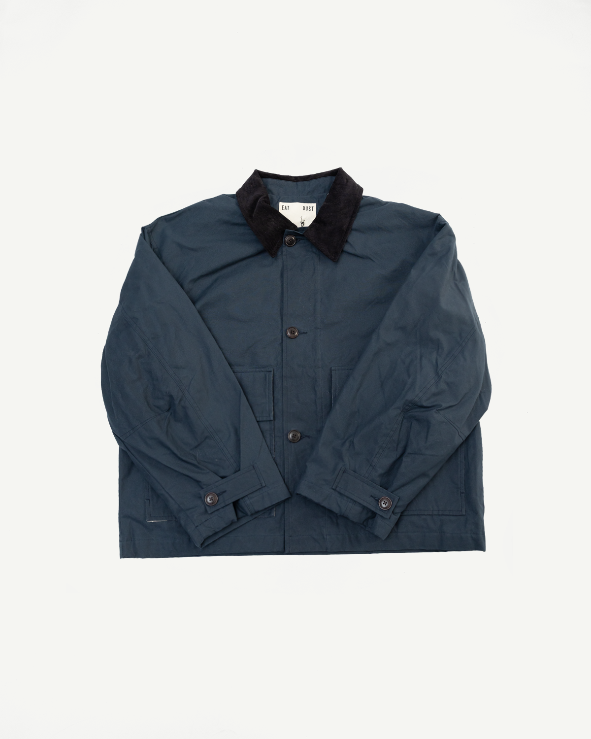 Front flat lay of navy dry wax cotton jacket with black collar, button details, visible pockets.