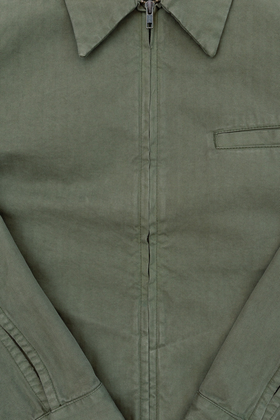 Close-up front view of olive green jacket showing zipper detail and fabric texture.