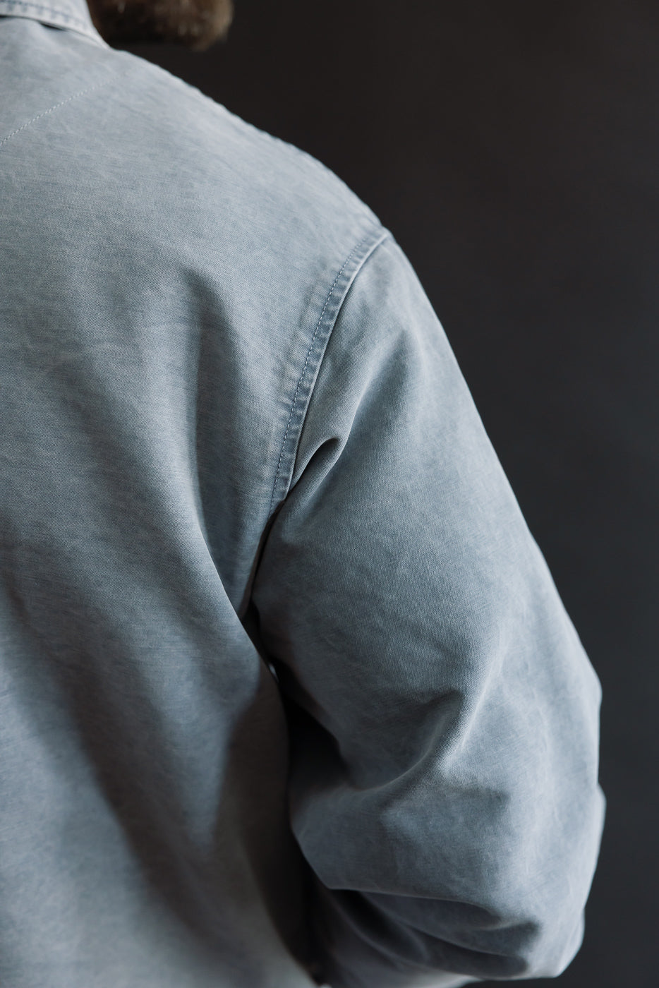 M-B-006 - Coach Jacket Nebraska Cotton - Coastal Blue showcases a textured upper back view with defined seam lines on a relaxed fit, ideal for layering, embodying Dant's premium workwear aesthetic.
