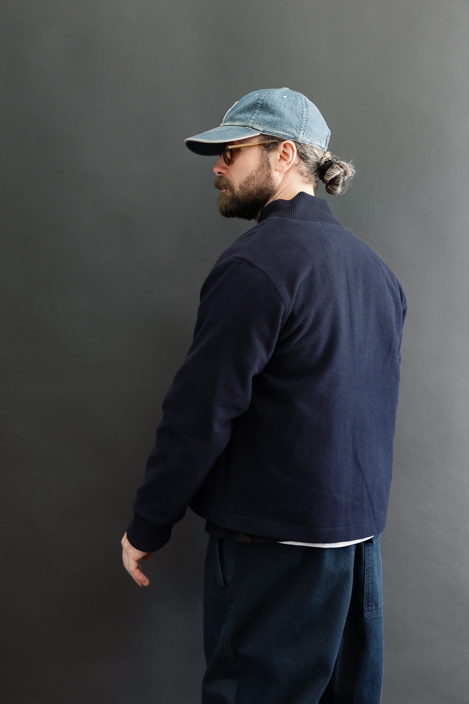 Back view of navy blue knit sweater on 5'9