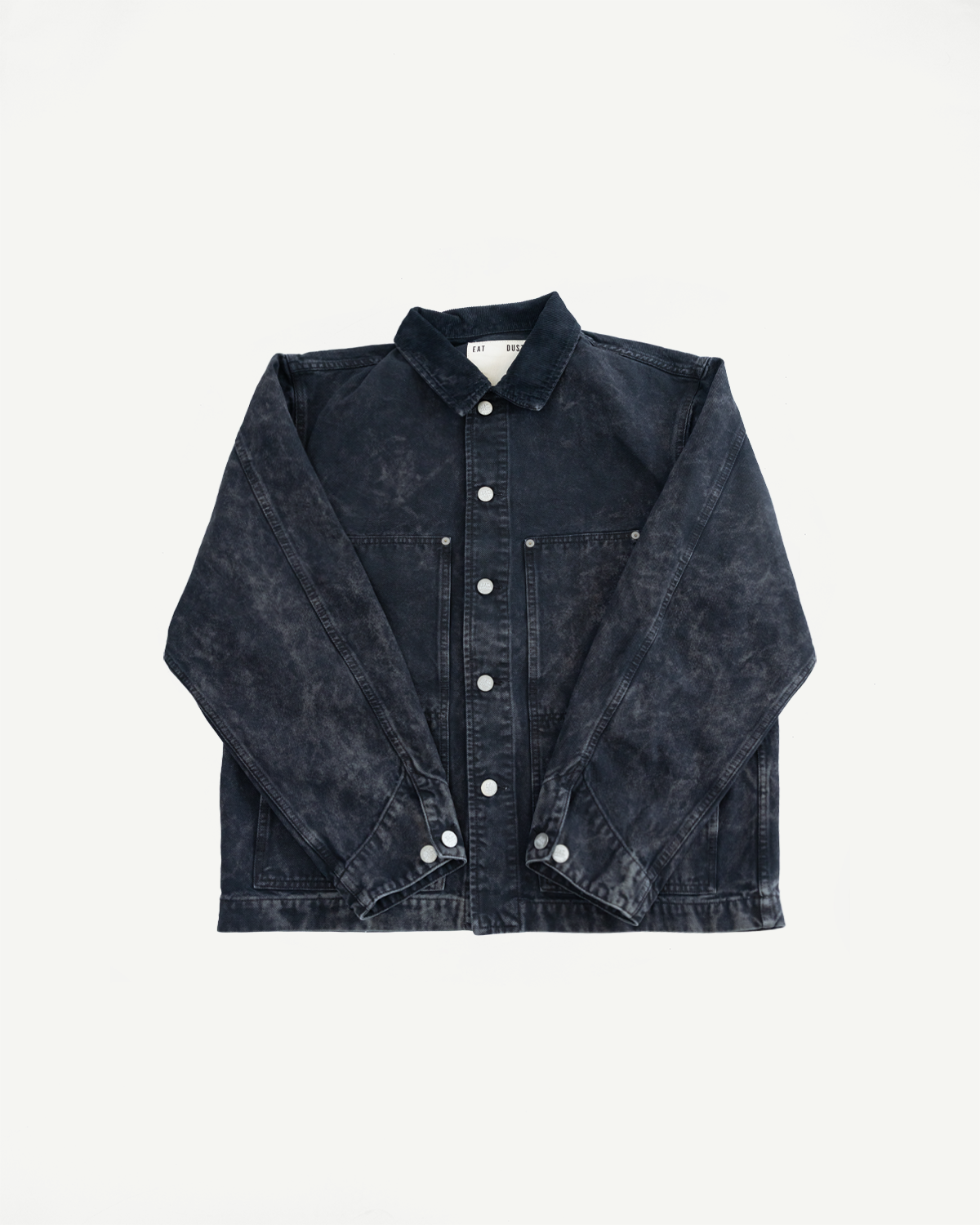 Flat lay of men's canvas jacket, front view, showing snap buttons, chest pockets, spread collar.