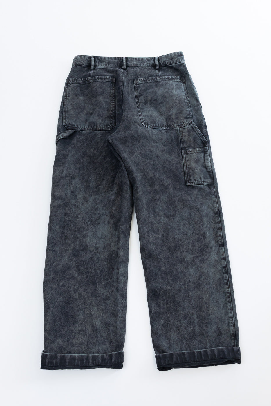 Flat lay back view of asphalt canvas chinos, showing rear patch pockets and side utility pocket.