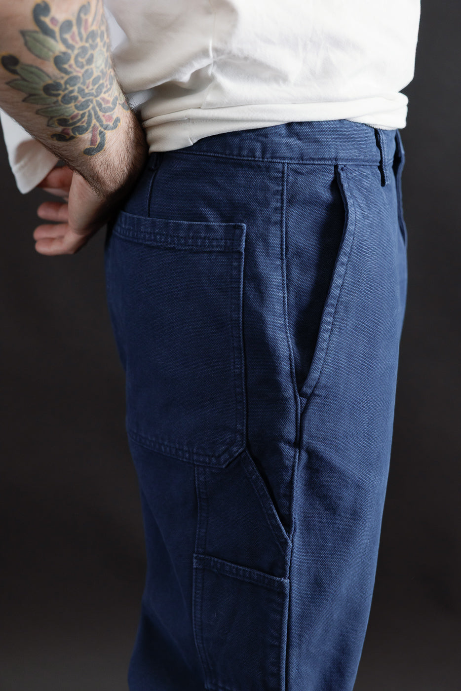 Close-up right side of indigo blue canvas chinos, male model 5'9