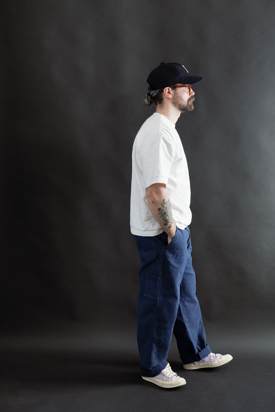 Male model 5'9 165lbs athletic build, side view, wearing indigo blue canvas chinos, Dant contemporary casual apparel