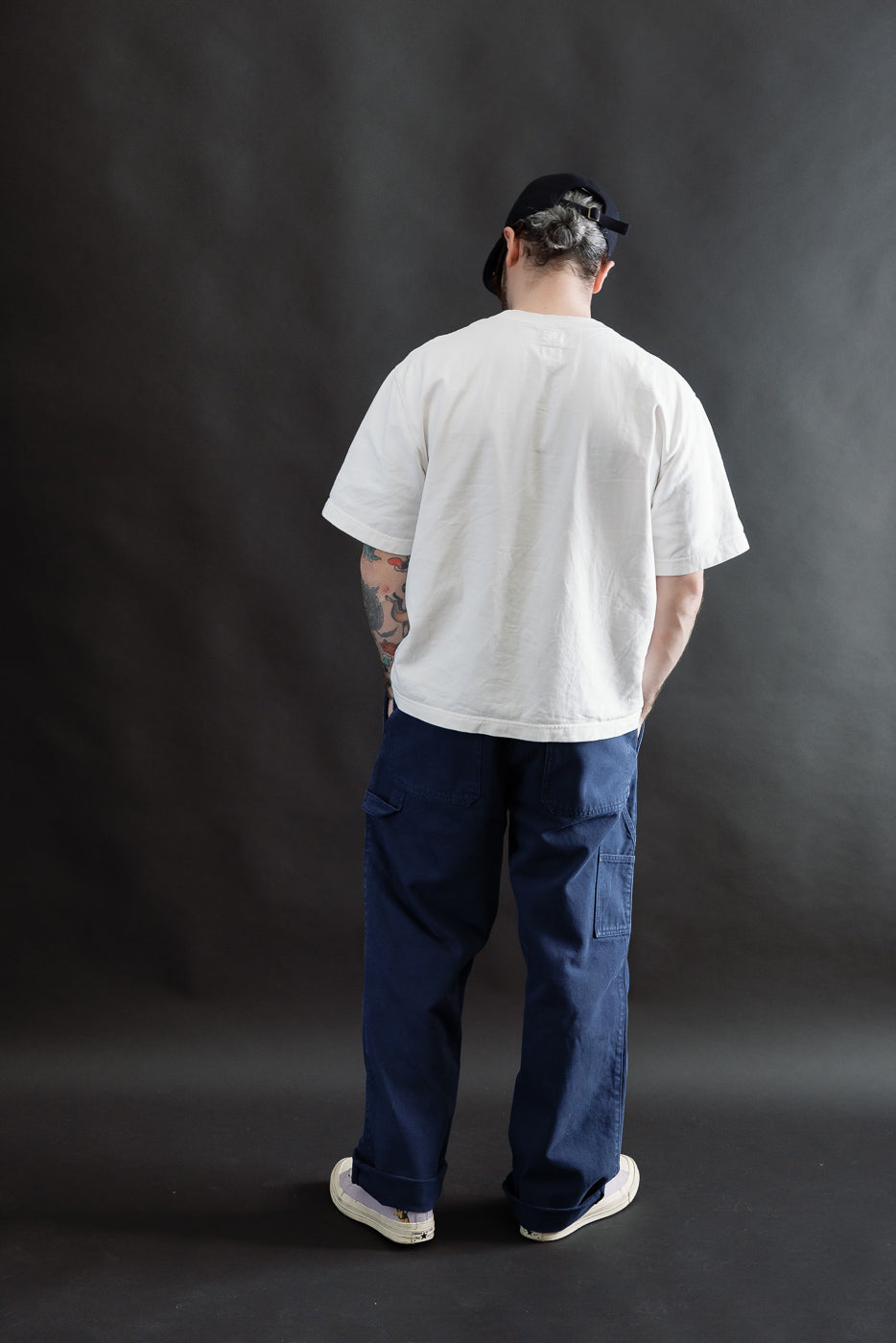 Male model 5'9 165lbs athletic build wearing indigo blue canvas chinos, back view full body