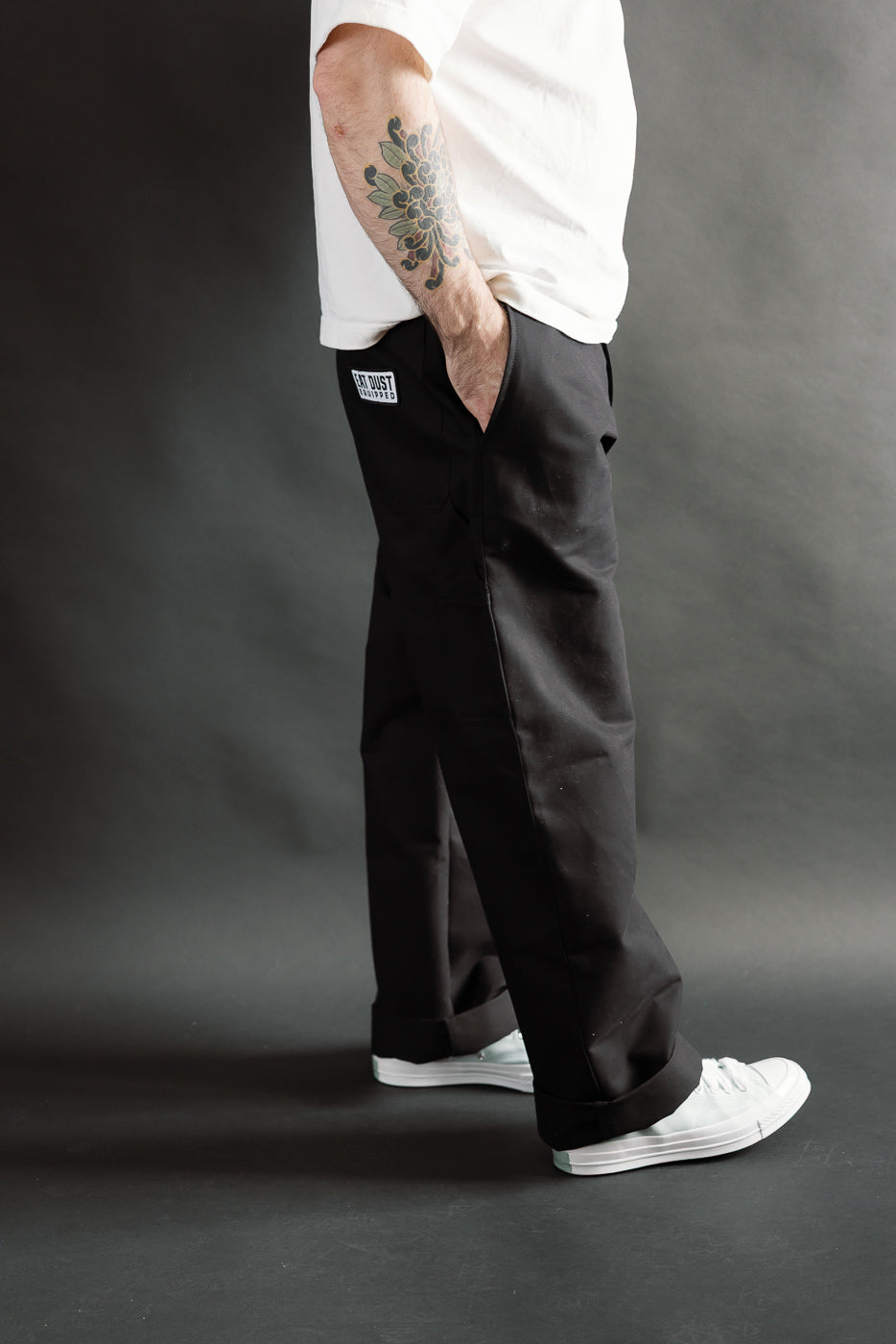 Side view close-up of black Oakland Chino pants on male model 5'9