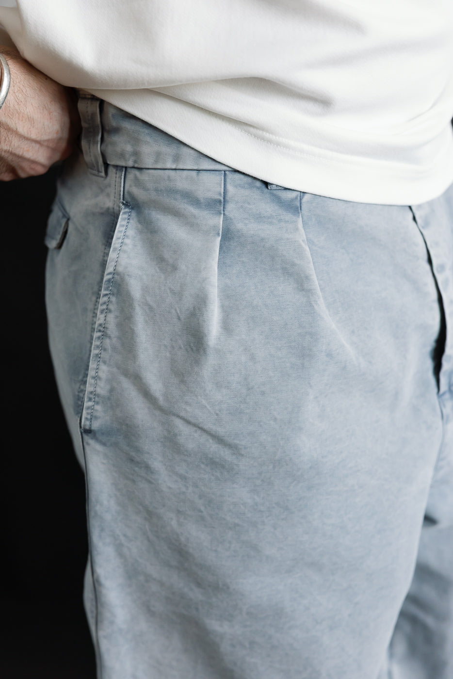 Close-up of front left hip and waist of men's coastal blue cotton chinos on 5'9