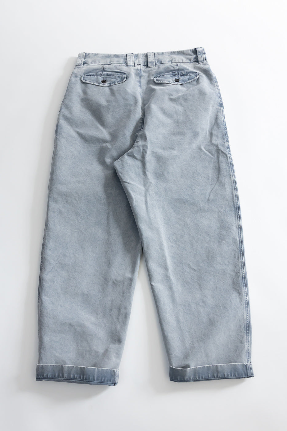 Flat lay, back view of coastal blue cotton chino pants, showing back pockets and cuffed hem.