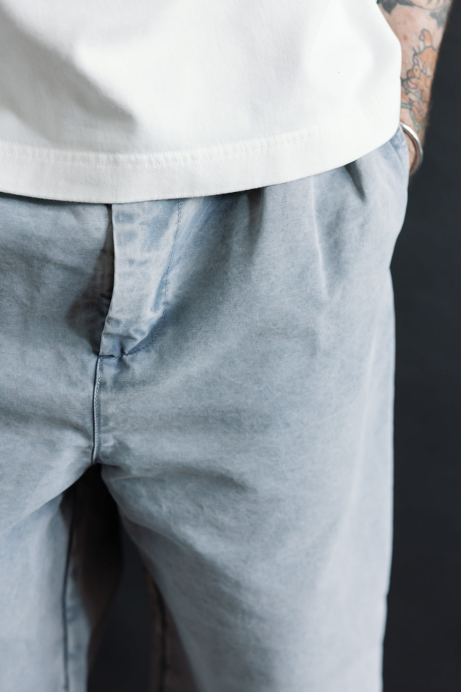 Close-up front view of coastal blue cotton chino pants, male model, athletic build, 5'9 165lbs, waistband and front pocket details visible.