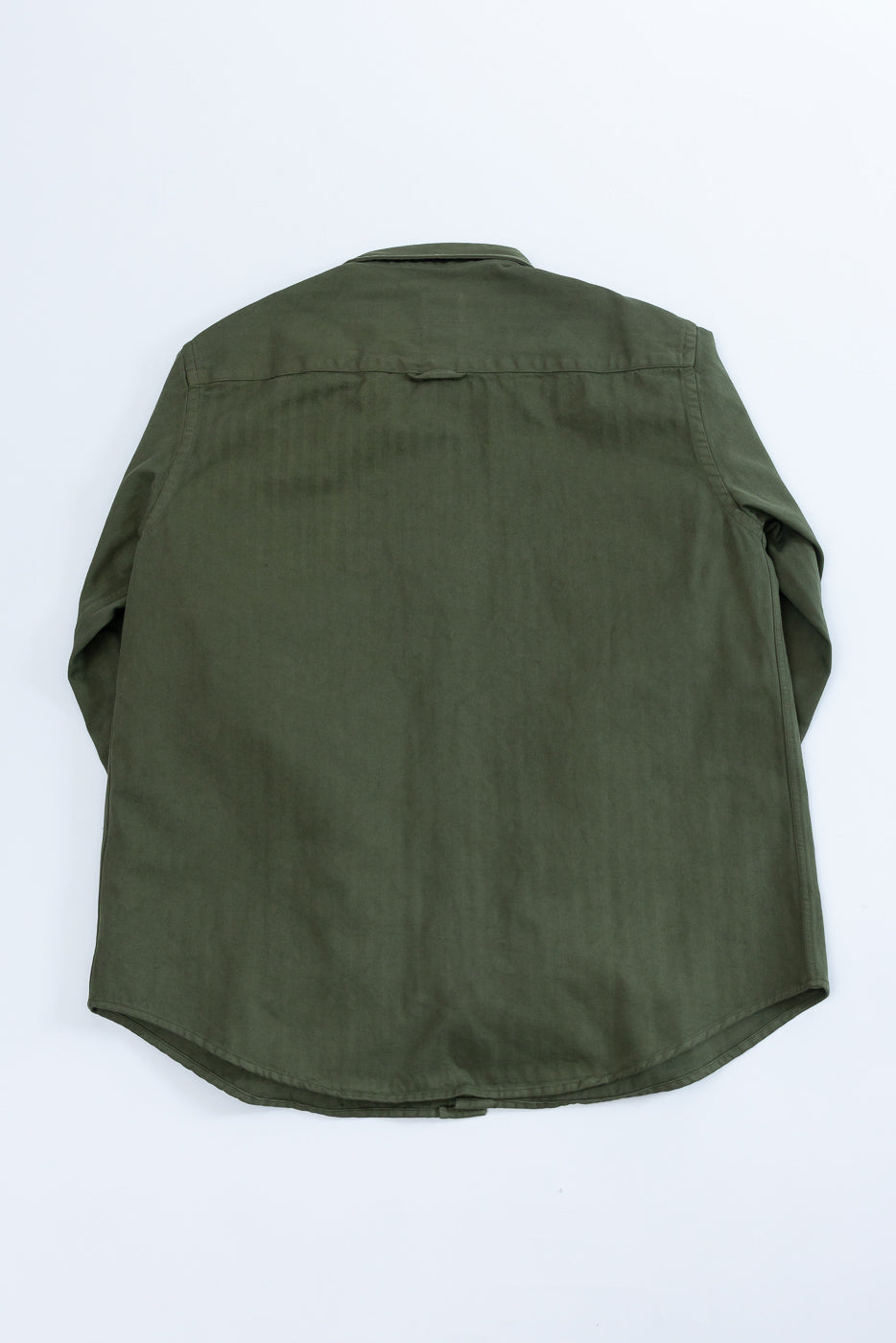 Flat lay of the back of an olive green long-sleeve button-down shirt.