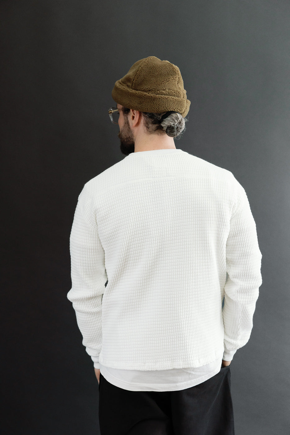 Back view of a white waffle-knit shirt on a 5'9