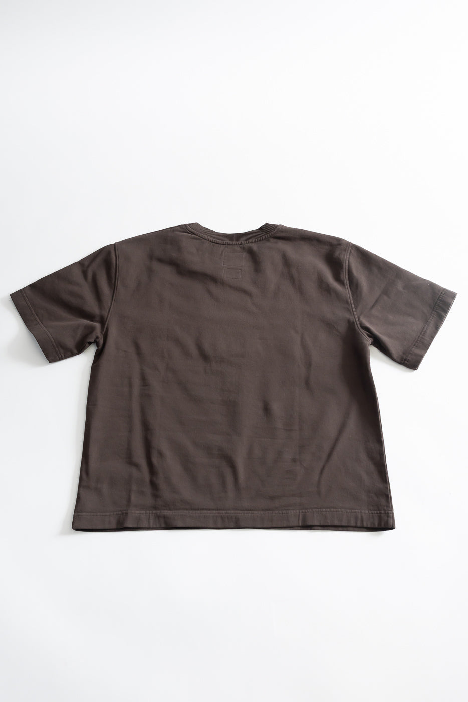 Back view flat lay of coffee brown twill short sleeve t-shirt, shows hem and collar stitching.