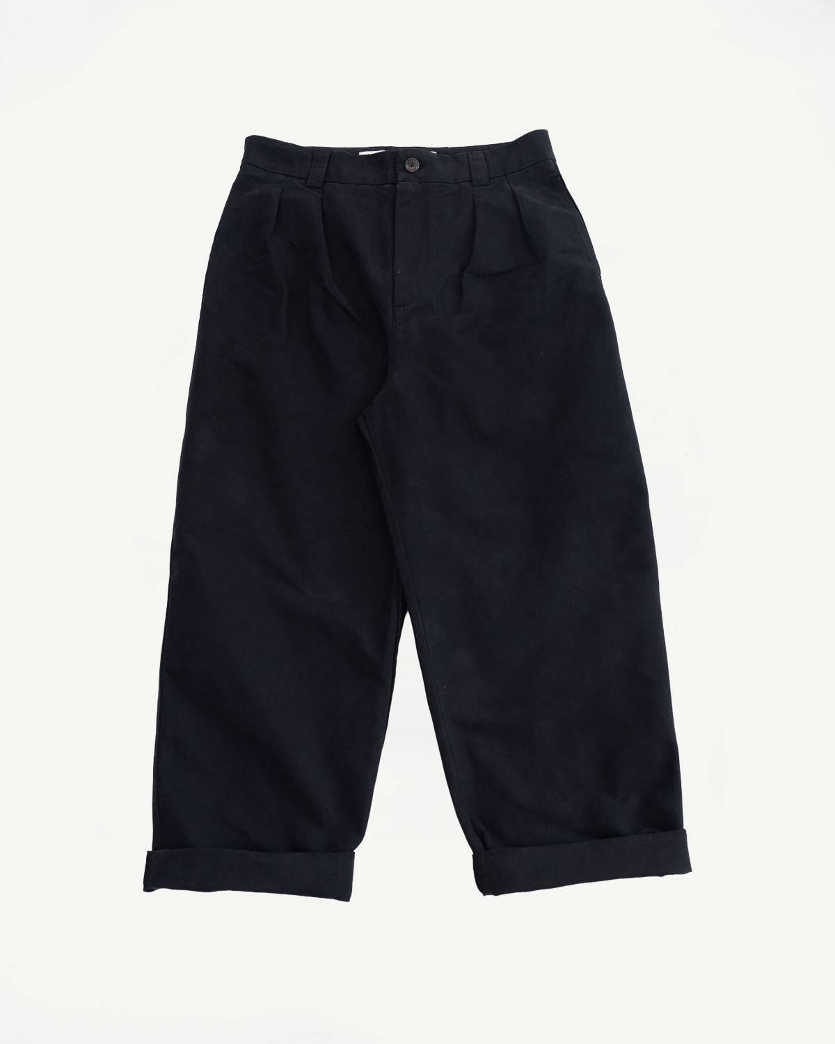 Front view flat lay of black wide-leg casual trousers with cuffed hems.