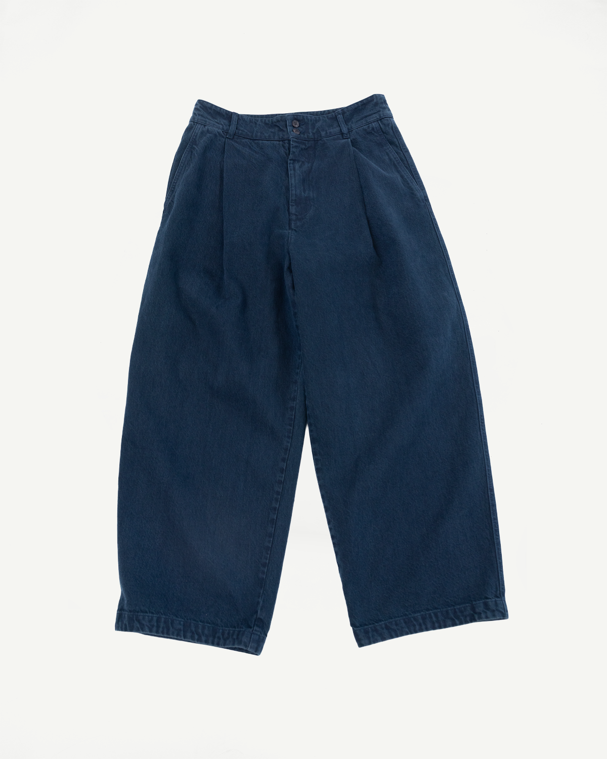 Front view flat lay of wide-leg navy blue denim trousers with pleated waist.