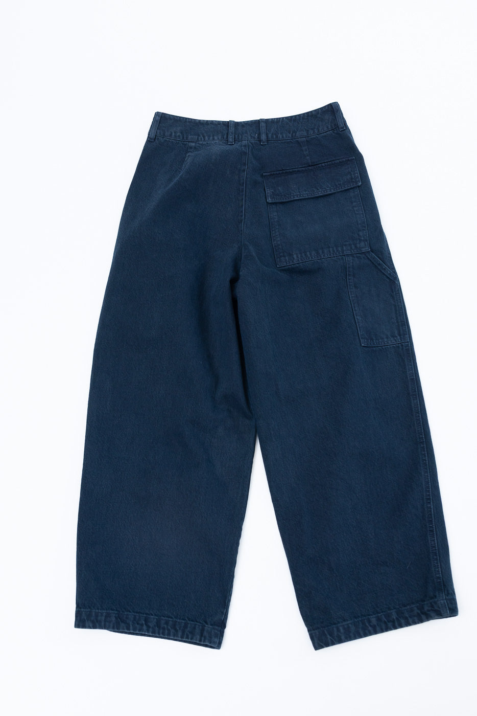 Back view flat lay of navy blue wide-leg casual trousers showing large cargo pocket detail.