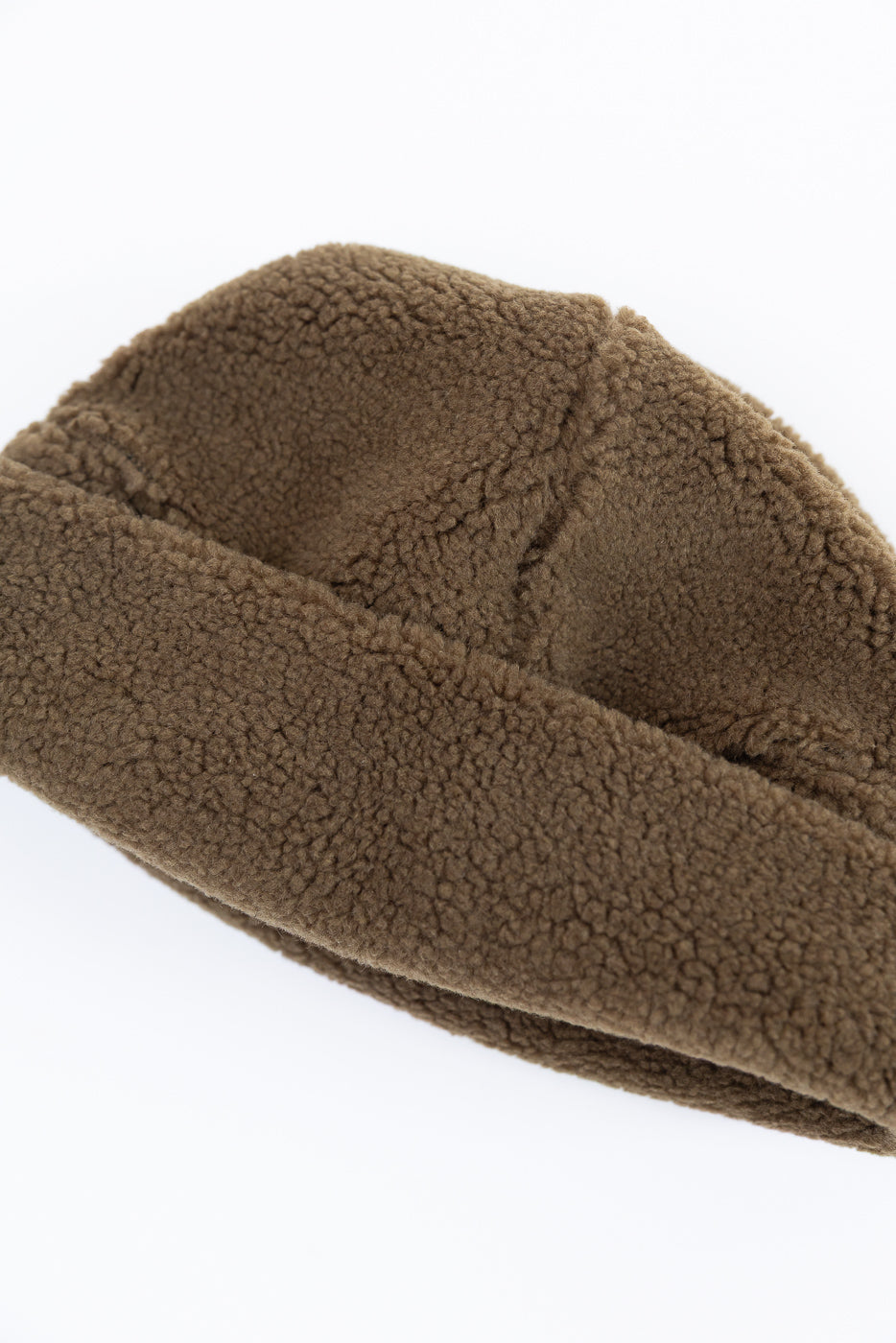 Close-up of the brown textured fleece fabric on the side of a beanie.
