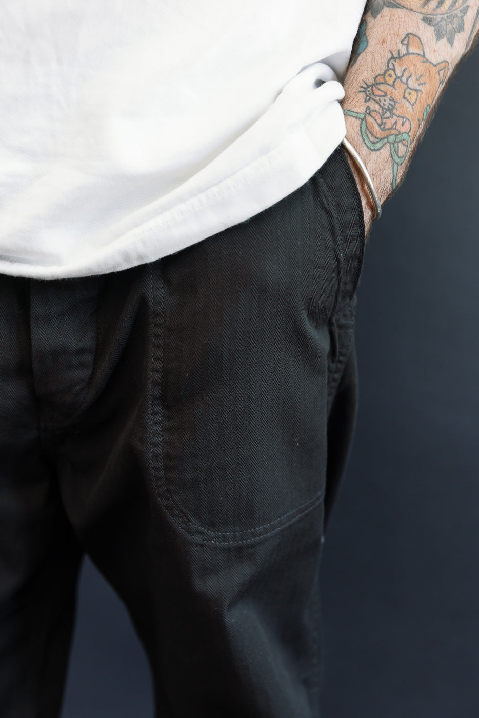 Close-up of black herringbone pants front, male model 5'9
