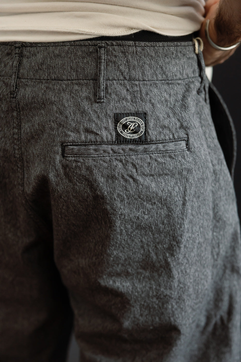 Close-up back view of dark gray selvedge pants, male model 5'9