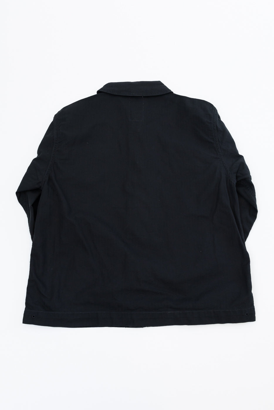 Back view of black casual shirt, flat lay, showing collar and hem details