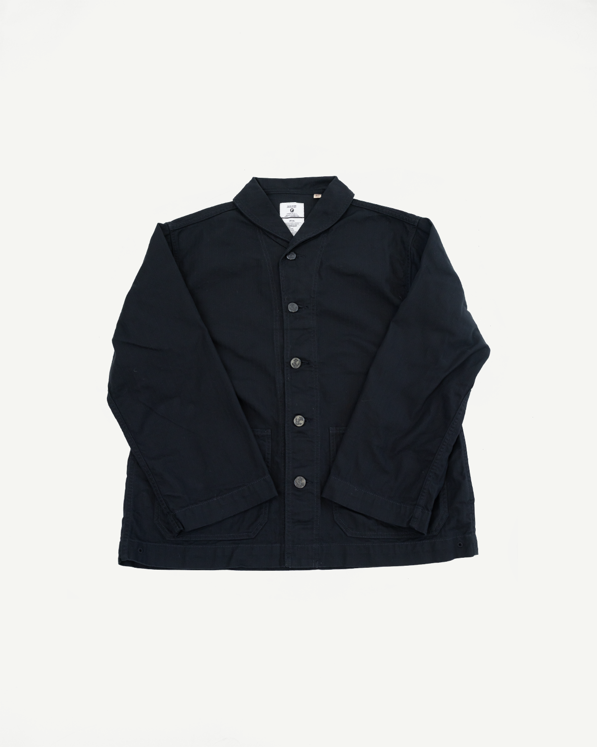 Front view of black button-up jacket with collar, pockets, and tag detail on flat lay