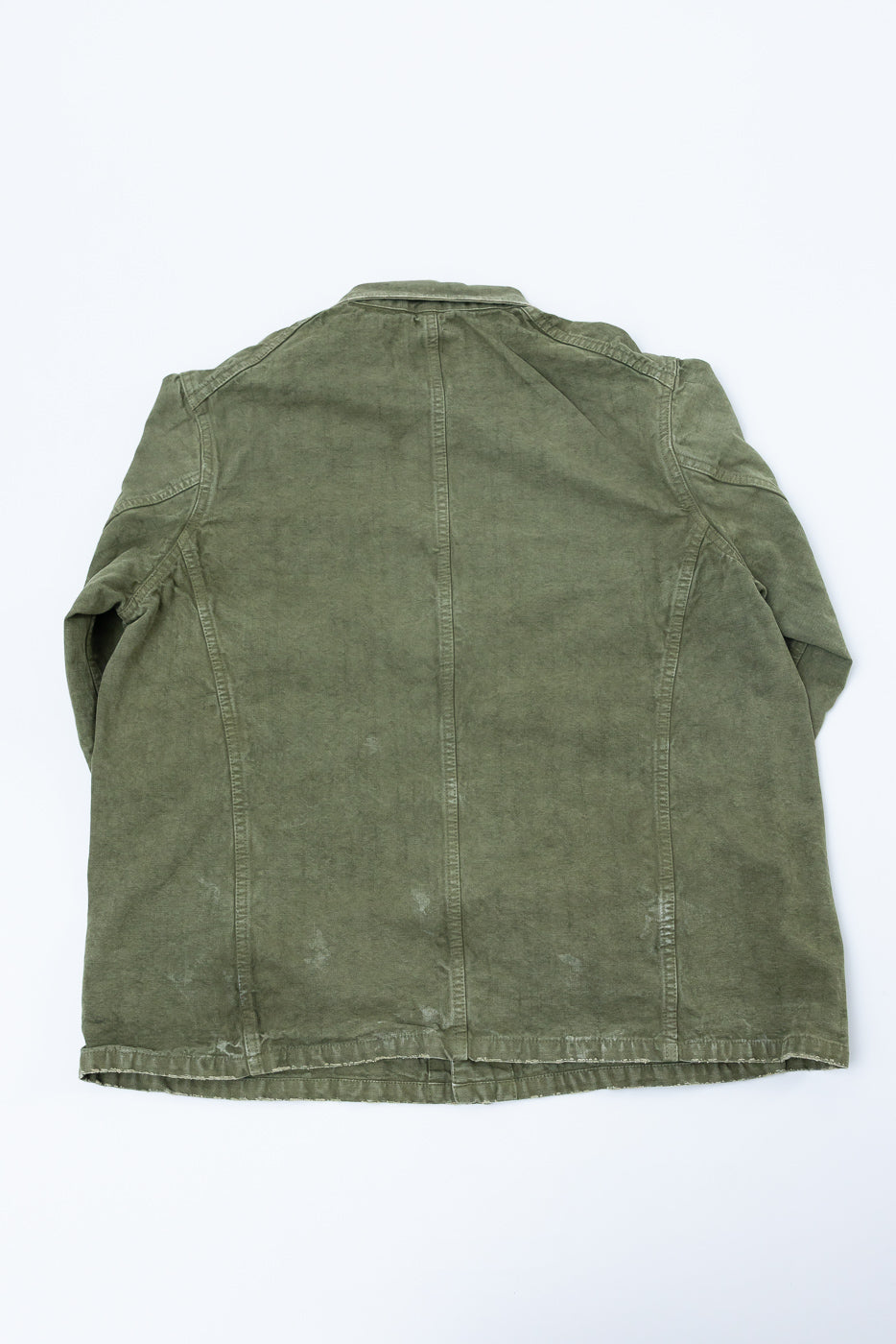 Back view of olive green corduroy jacket, flat lay, showcasing texture and hem details