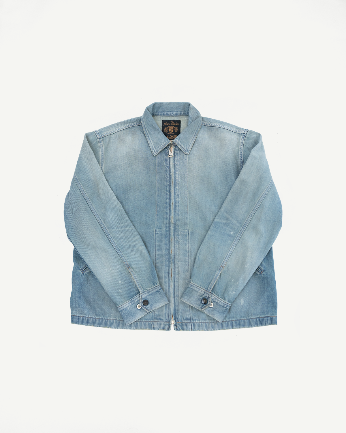 Front view of light blue denim jacket with zipper, collar, and buttoned cuffs, laid flat.