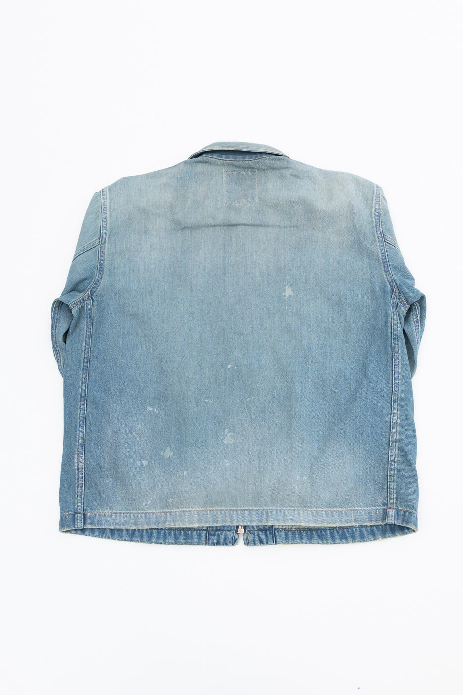 Back view flat lay of light wash denim jacket with faded spots, selvedge hem, and collar detail