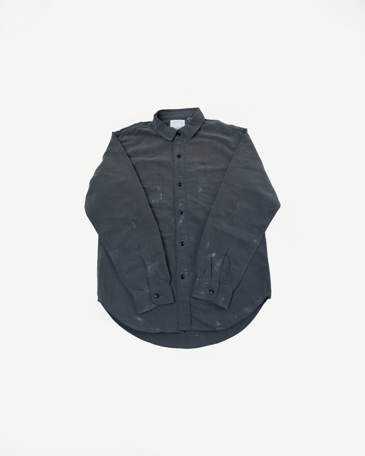 Front flat lay of dark gray button-up shirt with chest pockets, black buttons, and curved hem.