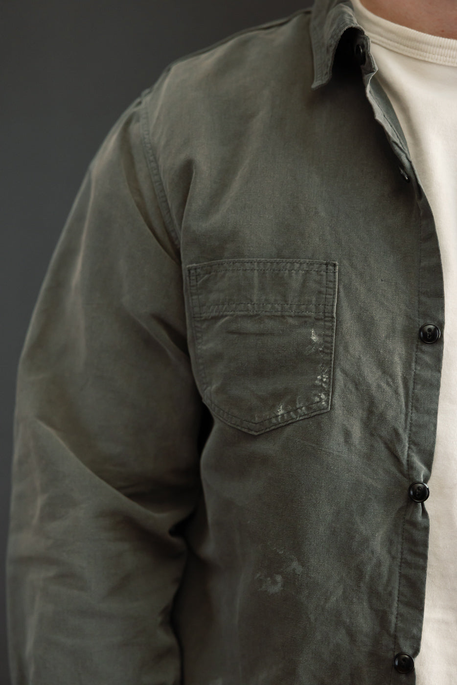 Close-up front view of olive shirt, male model, athletic build, showing chest pocket and buttons