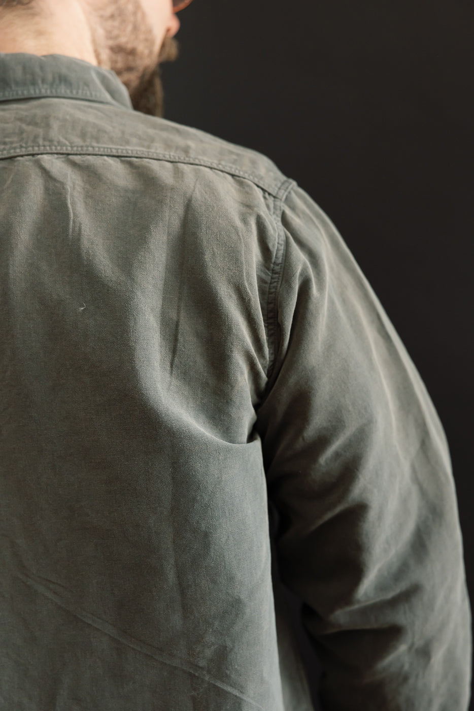 Back view of olive shirt on male model, 5'9